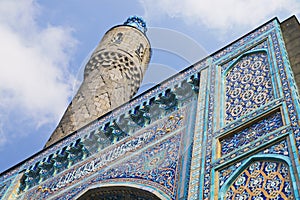 Minaret and the front wall with Arabic mosaics