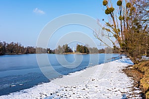 Minaret at Lednice castle, Czech Republic UNESCO historical place, the lake in foreground