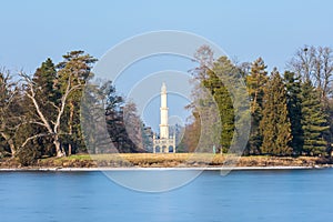 Minaret at Lednice castle, Czech Republic UNESCO historical place, the lake in foreground