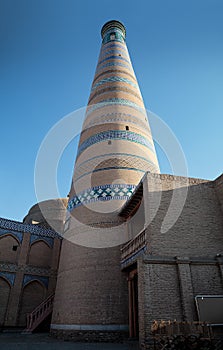 Minaret of madrasah Islom-hoja in a old city Ichan Qala in Khiva Uzbekistan photo