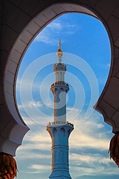 Minaret of Mosque, Abu Dhabi, United Arab Emirates. Typical sunset sky with colorful clouds