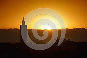 Minaret of mosque with sunset