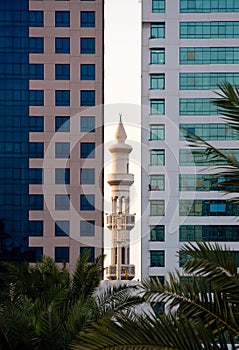 Minaret peeping between office buildings