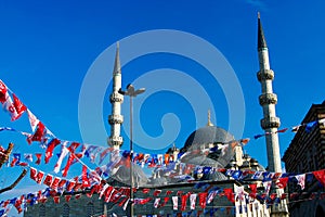 minarets and dome of Sultan Ahmed blue Mosque against sky decorated with flags, Istanbul, Turkey