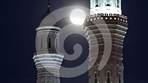 Minarets of The Hazrat Sultan Mosque in Astana timelapse at night with full moon, Kazakhstan