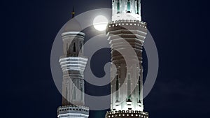 Minarets of The Hazrat Sultan Mosque in Astana timelapse at night with full moon, Kazakhstan