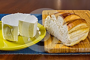 Minas frescal cheese with homemade bread. Typical cheese from the State of Minas Gerais / Brazil alongside homemade bread under cu