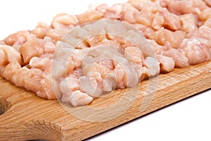 Minced chicken meat on wooden board