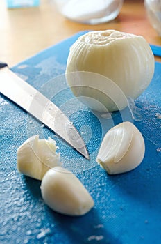 Minced garlic on a cutting board on a background of chef knife