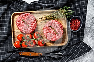 Minced meat burger cutlets. Gray background. Top view
