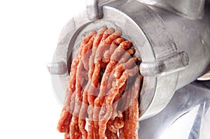 Minced meat comes fresh from a mincer