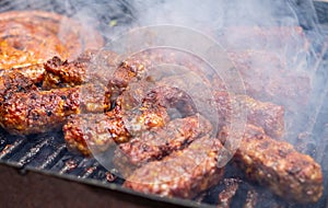 Minced meat rolls or mici cooking on barbecue traditional romanain balkan ottoman dish 1st of may labor day celebration