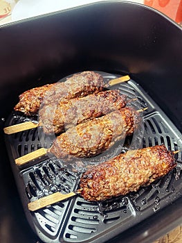 minced meat on wooden toothpicks, Greek souvlaki, meat baked in airfryer