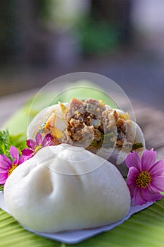 Minced Pork with Boiled Egg steamed bun hand made on banana leaf close up