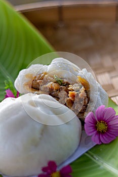 Minced Pork with Boiled Egg steamed bun hand made on banana leaf close up