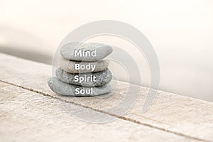 Mind, Body, Spirit and Soul words written on zen stones. Copy space and zen concept
