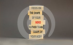 Mind or body symbol. Concept words Focus on the shape of mind rather than shape of your body on wooden blocks. Beautiful grey