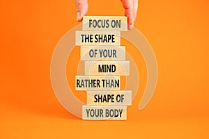 Mind or body symbol. Concept words Focus on the shape of mind rather than shape of your body on wooden blocks. Beautiful orange