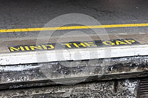 Mind the gap warning painted on railway platform