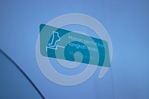 Mind your step sign on a white wall