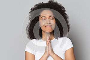 Mindful hopeful african american millennial woman praying, asking for help.