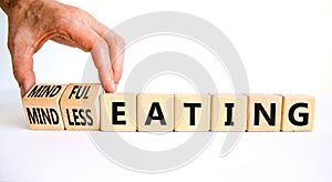 Mindful or mindless eating symbol. Doctor turns cubes and changes words mindless eating to mindful eating. Beautiful white