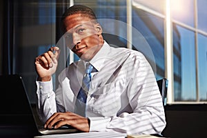 Mindfully focusing on the positive. a businessman sitting thoughtfully in his office.