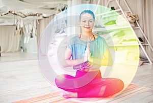 Woman meditating in lotus pose at yoga studio photo
