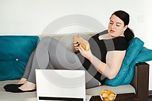 Woman eating unhealthy food watching series online