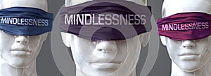 Mindlessness can blind our views and limit perspective - pictured as word Mindlessness on eyes to symbolize that Mindlessness can photo