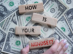Mindset symbol. Wooden blocks with words How is your Mindset. Beautiful dollar background. Businessman hand. Business and How is