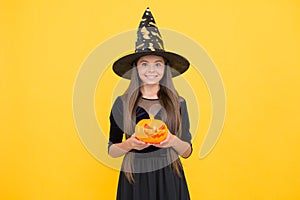 This is mine. costume party fun. jack o lantern. happy halloween. child in witch hat. kid hold spooky pumpkin