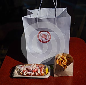 Lobster roll with french fries served at the Rex Burger & Lobster restaurant in Long Island, New York