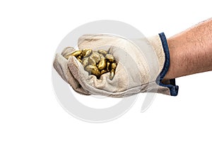 Miner hand with protective glove holding gold ore, golden metallic stone, isolated white background. Steelmaking or mining concept