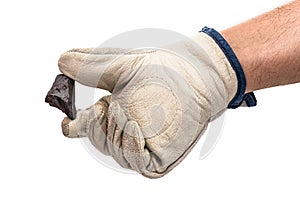 Miner hand with protective glove holding metallic rock, isolated white background. Steelmaking or mining concept