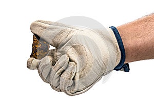 Miner hand with protective glove holding metallic rock,  white background. Steelmaking or mining concept