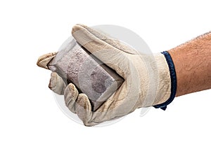 Miner hand with protective glove holding silver bar, metallic stone,  white background. Steelmaking or mining concept
