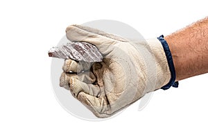 Miner hand with protective glove holding silver color ore, metallic stone, isolated white background. Steelmaking or mining