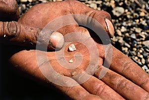 Miner hands rough diamond