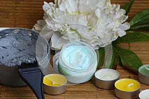 Mineral face and body mask, scrab and candles photo
