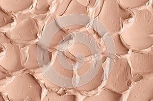 Mineral make-up liquid foundation concealer, face cream texture close up, selective focus. Abstract background, brush strokes.