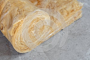 Mineral rockwool lying on attic floor inside house under construction