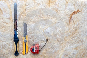 Mineral rockwool lying inside house under construction with special knife and measure type equipment