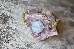 Mineral stone dragon fly glass bead bracelet on natural background