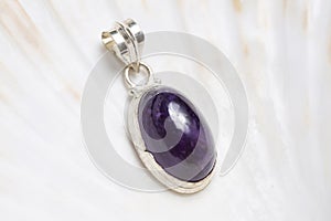 Mineral stone pendant on white shell background