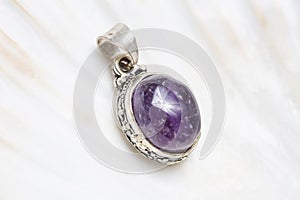 mineral stone pendant on white shell background