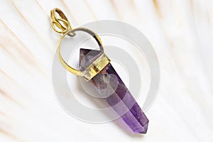 Mineral stone pendant on white shell background