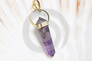 Mineral stone pendant on white shell background