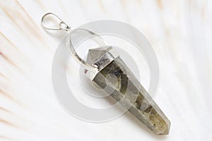 mineral stone pendant on white shell background