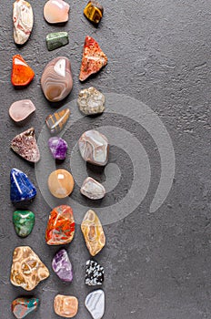Mineral stones on a black concrete background. The concept of using minerals in astrology and alternative or
